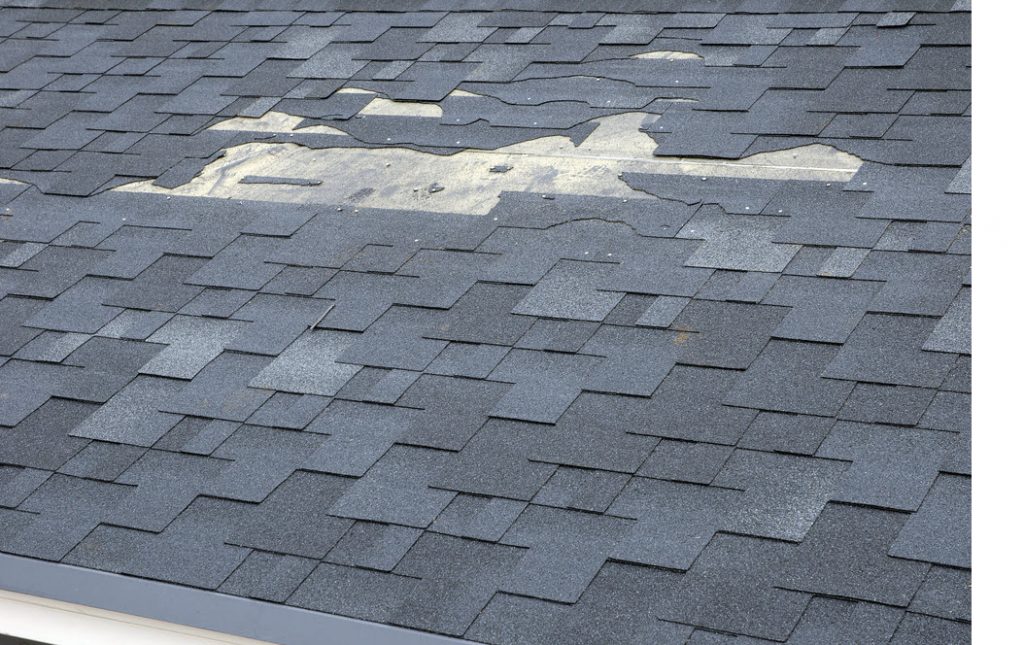 A close up view of shingles a roof damage.